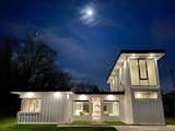 Exterior, Shipping Container Building Type, Metal Siding Material, Concrete Siding Material, Flat RoofLine, and House Building Type Evening front house  Photo 10 of 10 in Raynore Container Home by Chris R