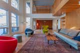 Double volume living room with bridge above and dining area beyond