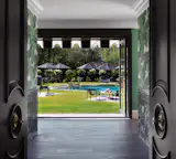 Custom doors frame the entry from the main house to the cabana.