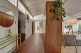 Hallway, Brick Floor, and Light Hardwood Floor Foyer  Photo 5 of 19 in Gorgeous Wood Abounds in This Immaculately Restored Colorado Midcentury Home from Wood Avenue Mid Century Stunner