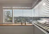 In this Sydney home strong western sun is blocked by elegant venetian blinds. #gwarchitect #blinds