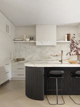 Kitchen, Range, Range Hood, White Cabinet, Marble Counter, Stone Slab Backsplashe, Cooktops, and Light Hardwood Floor Kitchen  Photo 2 of 16 in Family home in blush and bronze tones by Smac Studio