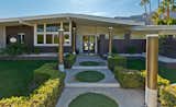 Front Entry inside a completely walled and gated front garden courtyard with illuminated columns