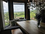 Dedicated dining area with east-facing panorama windows and built-in seating area that doubles as a storage for Christmas decorations. Chandelier is stainless steel and crystal