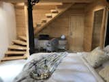 Master bedroom. The tree trunk that supports the stairs was cut below ground level to maintain the upper roots and give the appearance of coming out of the floor. The doorway leads to a small room suitable for sleeping infants with direct access from the master bedroom.