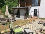 The backyard is still in progress but in this picture you can see a fire pit and a covered patio with an inflatable jacuzzi. 