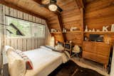 Bedroom, Wall Lighting, Dresser, Bed, Floor Lighting, Ceiling Lighting, Vinyl Floor, Table Lighting, Storage, Rug Floor, Chair, Shelves, and Night Stands Custom Pendleton pillows, original midcentury pieces, and artwork from former Nike Design colleagues can be found throughout the cabin.   Photo 6 of 13 in KÜLHAUS Cabin Tahoe by KULHAUS, llc