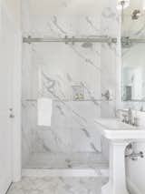 Marble flooring and countertops are used in the bathrooms.