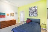 A brightly painted bedroom offers dramatic views to the north. A walk in closet , laundry and master bath are nearby.