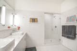 Crisp and Clean.  White tile in the spacious master bath. This is one of three full baths in this unit.