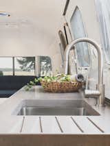 Guests can clean up with a view at the concrete farmhouse sink.