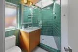 The green tile in the guest bath is divine and sunlit by the bright skylight above.