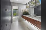 The floating vanity is surrounded by glazing; the result is dramatic horizontality.