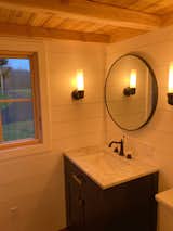 Bath Room, Marble Counter, Medium Hardwood Floor, Undermount Sink, Wall Lighting, Two Piece Toilet, and Enclosed Shower Bathroom vanity  Photo 9 of 9 in The Roost Roadster by Elizabeth Evans