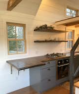 Kitchen Kitchen table folds up to comfortably seat 2 people.  Photo 3 of 10 in Roost Roadster Tiny House by Elizabeth Evans