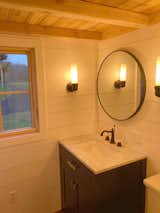 The bathroom has a 30" shower stall, Carrara marble vanity, closet and toilet of the buyer's choice (currently outfitted with a flushable toilet).