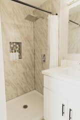 Bath Room, Engineered Quartz Counter, Porcelain Tile Wall, Recessed Lighting, Marble Wall, One Piece Toilet, Wall Lighting, Vinyl Floor, Ceiling Lighting, Full Shower, and Undermount Sink Single Shower in the Studio Bathroom  Photo 3 of 9 in San Diego Cool and Cozy Urban Oasis by Krystin Krebs