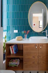 Each bathroom received a touch of the colorful and unique range of shades spotted in the house- green rectangular tiles, unique blue colored tiles and one with white tiles and green floor.