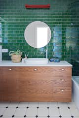 Common to all bathrooms is a dark wood chest of drawers that blends in with the colors of the bathrooms and adds a natural touch to them.