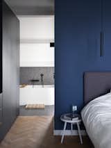 Bedroom, Bed, Light Hardwood Floor, Pendant Lighting, Ceiling Lighting, and Ceramic Tile Floor  Photo 7 of 13 in Black Timber Dykehouse by Arjen Reas Architects