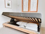 Daybed stores linens and easily turns into a double bed.