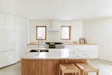 Custom curved birch island with natural quartzite countertop.