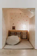 'Kid's Cave' play area stocked with games, lego, train set, stacking cups, and books.