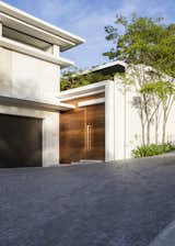 Exterior, Stone Siding Material, Flat RoofLine, House Building Type, and Concrete Siding Material Street Entrance Door  Photo 16 of 25 in Avenue Fresnaye Villa by Jenny Mills Architecture & Interiors