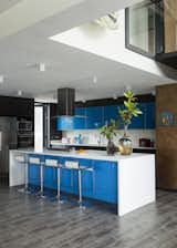 Kitchen, Engineered Quartz Counter, Range Hood, Refrigerator, Microwave, White Cabinet, Medium Hardwood Floor, Ceiling Lighting, Drop In Sink, Dishwasher, Colorful Cabinet, Cooktops, Glass Tile Backsplashe, and Wall Oven Kitchen  Photo 16 of 32 in Welgedacht Villa by Jenny Mills Architecture & Interiors