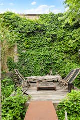 Deck with brick wall covered in ivy