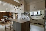 Kitchen, Porcelain Tile Backsplashe, Pendant Lighting, Cooktops, Wood Cabinet, Dishwasher, Range Hood, Ceramic Tile Floor, Engineered Quartz Counter, White Cabinet, Undermount Sink, and Wall Lighting  Photo 3 of 10 in Ten by Doran by Jaclyn