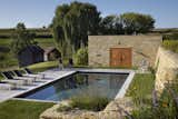 Outdoor, Side Yard, Swimming Pools, Tubs, Shower, Retaining Fences, Wall, Wood Patio, Porch, Deck, and Stone Fences, Wall A terraced pool surrounded by stone walls provides privacy.   Photo 2 of 5 in Thistle Hill Farm by Northworks Architects