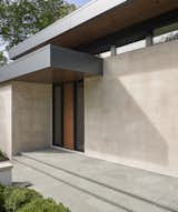 The street-facing side of the building features a minimalist entry with clerestory windows to provide privacy. 