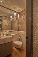 The expensive Baccarat wall lamp is an inspiration in the guest toilet with a secret door that can connect to the second bathroom in the apartment.