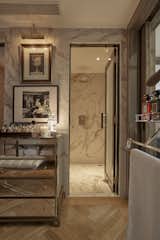 Bath Room, Freestanding Tub, Marble Counter, Marble Wall, Ceiling Lighting, Light Hardwood Floor, and Wall Lighting The secret bathroom can connect to the guest toilet in the second bedroom  Photo 18 of 25 in WOW SUITE in Saigon