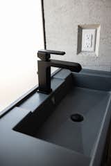 The guest bath custom concrete sink by Hard Goods features a turquoise inlay from Kingman, AZ. 