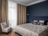 In the bedroom – deep blue colour, moldings and sconces.