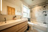 Bath Room, Engineered Quartz Counter, Two Piece Toilet, Ceiling Lighting, Full Shower, Soaking Tub, Marble Wall, Wall Lighting, Undermount Sink, and Ceramic Tile Floor One of two bathrooms  Photo 7 of 10 in Mesa House by Alexandra Fuller