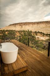 Outdoor, Back Yard, Trees, Desert, Grass, Shrubs, Large Patio, Porch, Deck, Hot Tub Pools, Tubs, Shower, and Wood Patio, Porch, Deck In every season, the outdoor bathtub is the owner's part of Mesa House.  Photo 8 of 10 in Mesa House by Alexandra Fuller