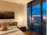 Bedroom, Bed, Ceiling Lighting, and Medium Hardwood Floor Master bedroom with city views  Photo 3 of 8 in Downtown Miami’s Brickell Flatiron Condominium Unveils Last Remaining Duplex Penthouse, Listed for $9.4 Million by paola