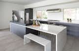 Contemporary kitchen design lets more light into the space with large windows instead of wall cabinetry