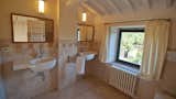 Bath Room, Granite Counter, Travertine Floor, Wall Lighting, Ceiling Lighting, Ceramic Tile Wall, Enclosed Shower, Wall Mount Sink, and One Piece Toilet All our bathrooms are huge and XXL size!  Photo 7 of 11 in Villa Caccianello by Linda Yaccarino