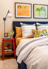 The Guest Bedroom with red enamel bedside tables with a pine shelves.