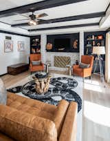 Chair, Console Tables, Living Room, Sofa, Bookcase, Coffee Tables, Light Hardwood Floor, Gas Burning Fireplace, and Ceiling Lighting Family Room  Photo 7 of 17 in Modern Farmhouse by Graig Cady Design