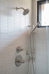 The primary bath shower was enlarged and updated with "Kit Kat" tiles in a matte finish.