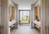 Four and a half bathrooms feature limestone flooring, custom-built Apaiser soaking tubs and floating vanities, as well as customized Hansgrohe indoor and outdoor rain showers.