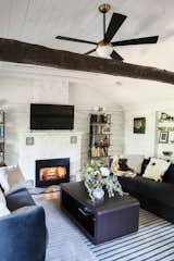 Cabin - original fireplace with new ventless gas insert, new hearth tiles. 'Trophy' shelves are where there was a small doorway between the original cabin and the 1980s ranch house.  Ceiling was raised from just inches above the log beam