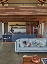 Kitchen, Refrigerator, Concrete Floor, Wood Cabinet, Laminate Counter, and Ceiling Lighting The two architects and their daughter Macarena  Photo 3 of 11 in Reinterpreting the rural house