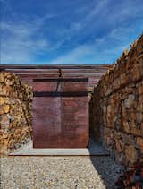 Exterior, Metal Roof Material, House Building Type, and Stone Siding Material A great gabion retaining wall made with local stones brings the Granada trademark to the architectonic proposal.  Photo 9 of 11 in Reinterpreting the rural house