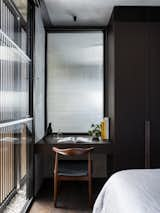 Bedroom, Chair, Ceiling Lighting, Dark Hardwood Floor, and Bench  Photo 9 of 74 in Alexander - Developed by Adjani by Aaron Hatch